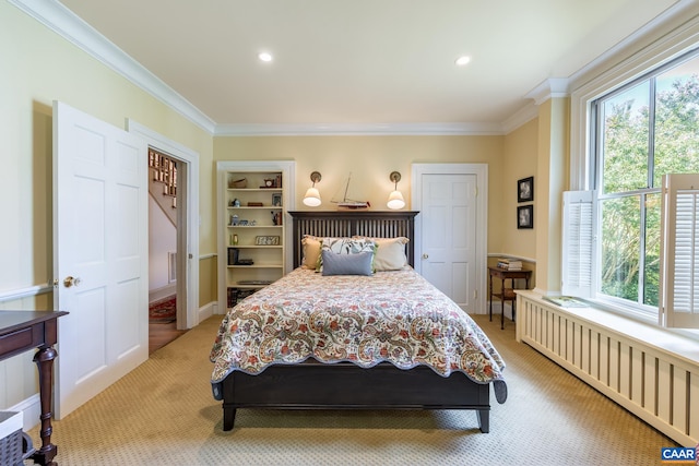 carpeted bedroom with crown molding and radiator