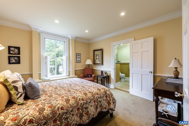 bedroom with ensuite bathroom, ornamental molding, and light colored carpet