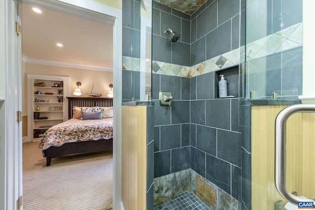 bathroom with a shower with door and ornamental molding