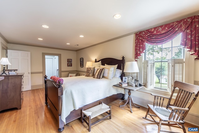 bedroom featuring ornamental molding and light wood-type flooring