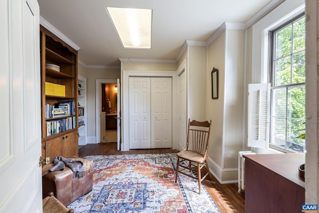 living area featuring crown molding, dark hardwood / wood-style floors, and radiator heating unit