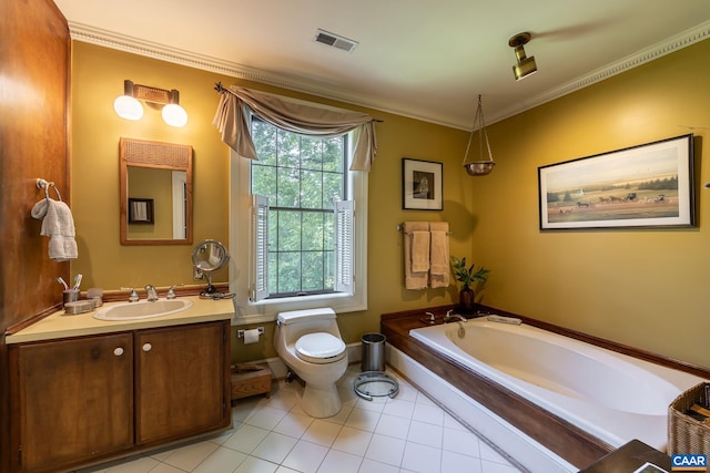 bathroom with crown molding, toilet, tile patterned floors, vanity, and a bathtub