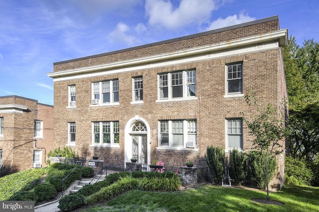 view of front facade with a front yard and cooling unit