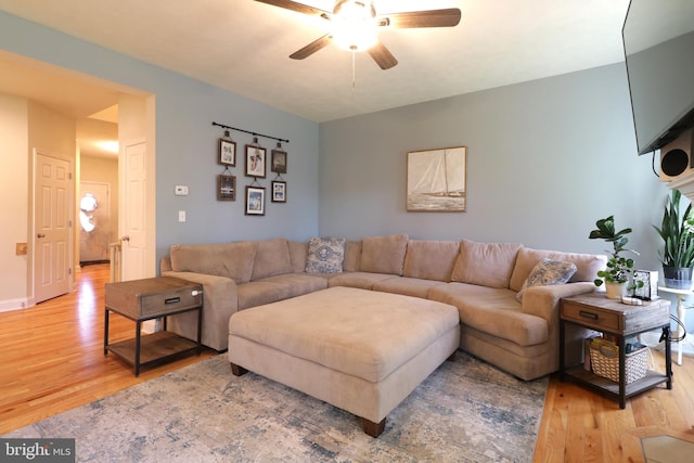 living room with hardwood / wood-style flooring and ceiling fan