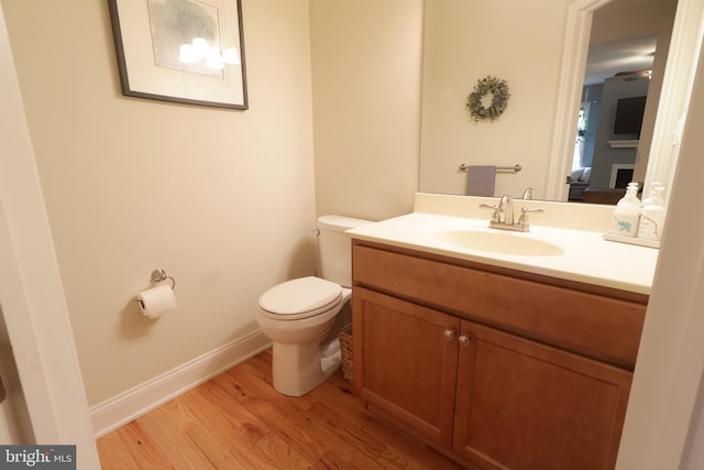 bathroom with vanity, hardwood / wood-style floors, and toilet