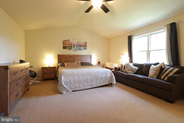 bedroom with vaulted ceiling, light colored carpet, and ceiling fan