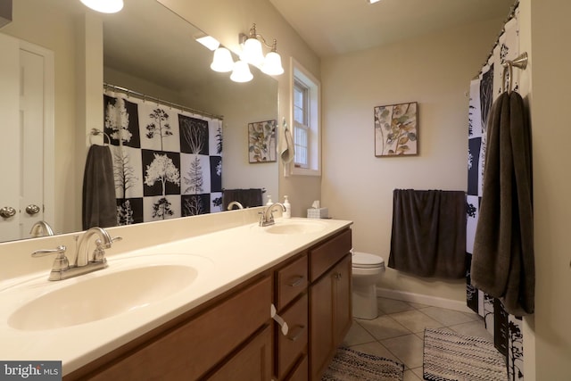 bathroom with vanity, toilet, and tile patterned flooring