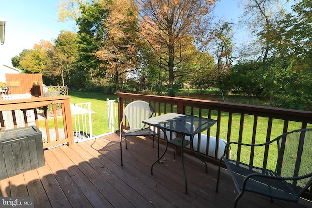 wooden terrace featuring a yard