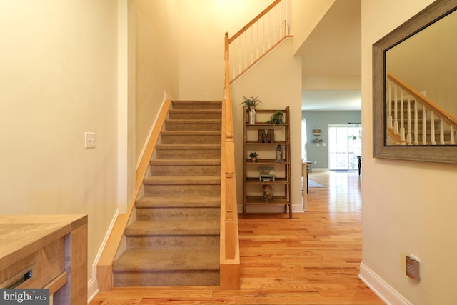 staircase featuring hardwood / wood-style floors