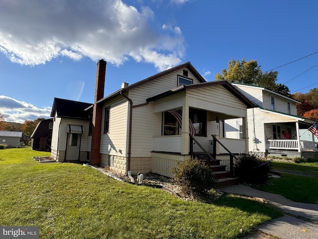 view of front of house with a front yard and a porch