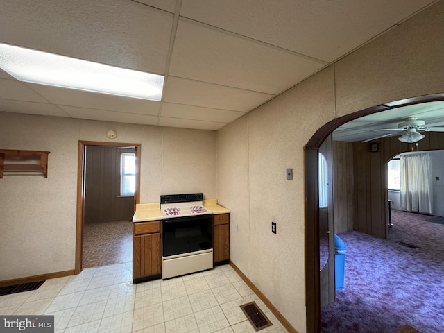 kitchen featuring white range with electric stovetop, a paneled ceiling, and ceiling fan