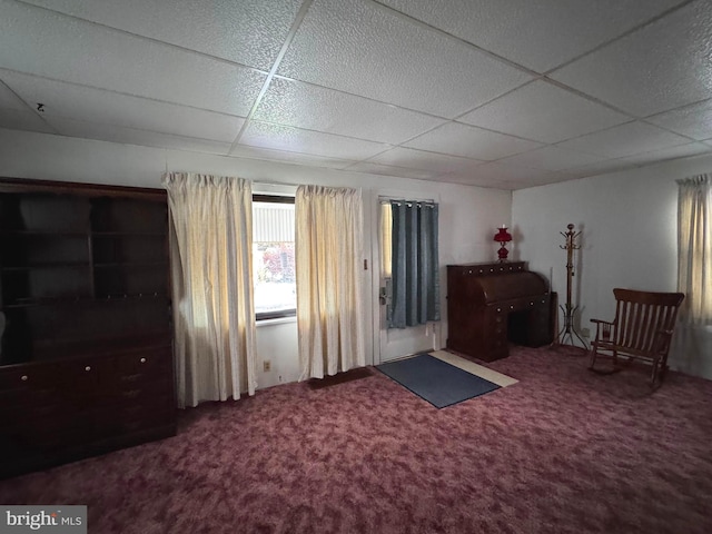 unfurnished room featuring a paneled ceiling and carpet floors