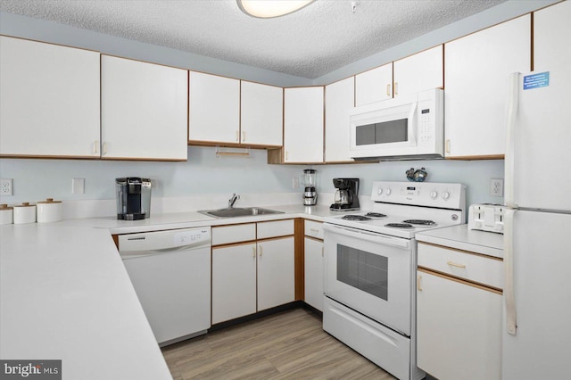 kitchen with white cabinetry, a textured ceiling, light hardwood / wood-style floors, sink, and white appliances