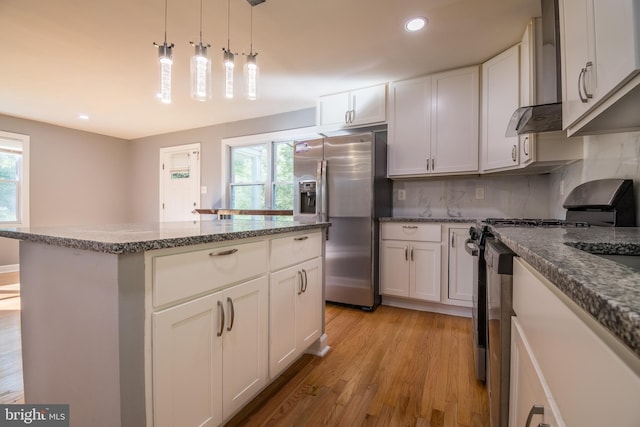 kitchen with a center island, light hardwood / wood-style flooring, stainless steel appliances, and plenty of natural light