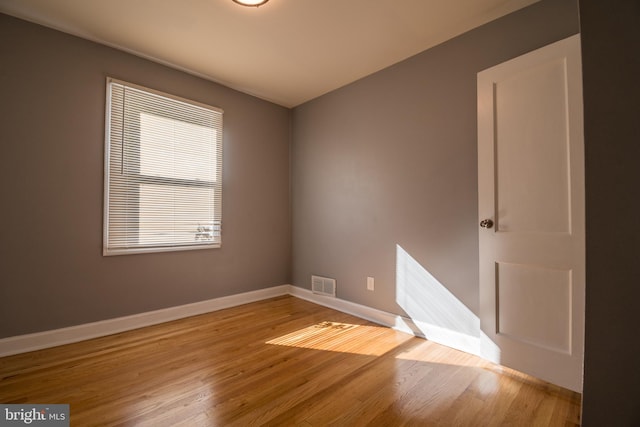 empty room with light hardwood / wood-style floors