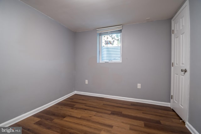 spare room with dark wood-type flooring