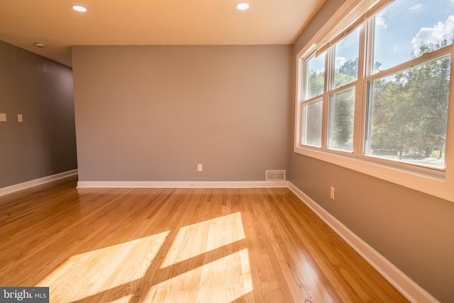 spare room featuring light hardwood / wood-style flooring