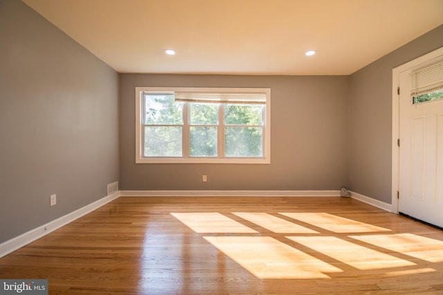 unfurnished room with light hardwood / wood-style flooring and plenty of natural light