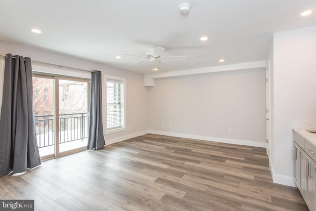 unfurnished room featuring light wood-type flooring and ceiling fan