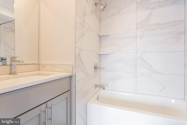 bathroom featuring vanity and tiled shower / bath combo