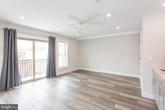 interior space with light hardwood / wood-style flooring and ceiling fan