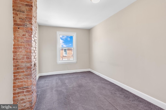 empty room with dark colored carpet