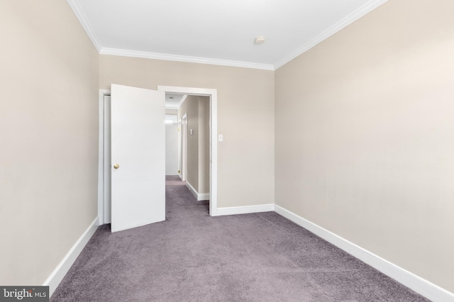 unfurnished room with carpet and crown molding