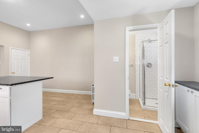 kitchen featuring light tile patterned floors and white cabinets