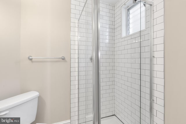 bathroom with toilet and an enclosed shower