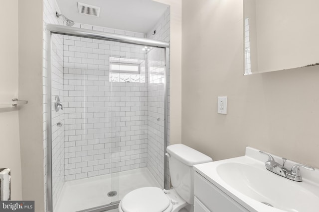 bathroom featuring vanity, toilet, and walk in shower