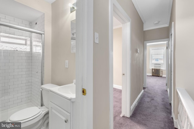 bathroom featuring a shower with door, toilet, radiator, crown molding, and vanity