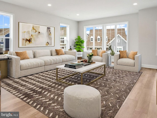 living room featuring a wealth of natural light and hardwood / wood-style flooring