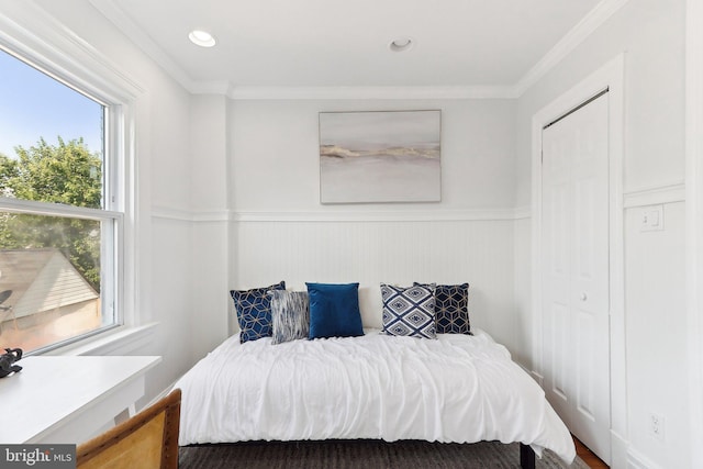 bedroom featuring crown molding and a closet