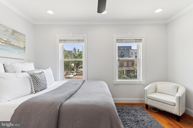 bedroom with wood-type flooring and ornamental molding