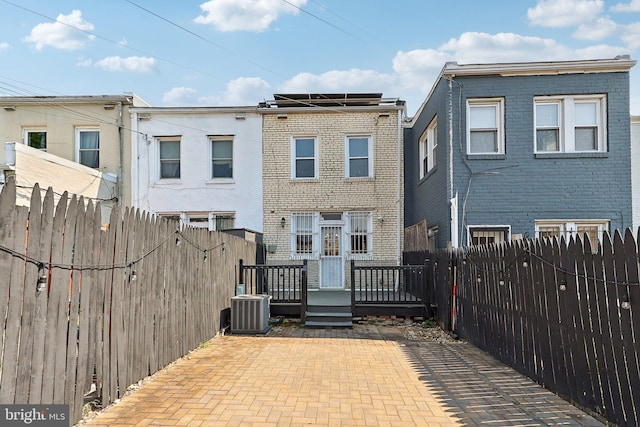 rear view of house featuring a patio, a deck, and central AC unit