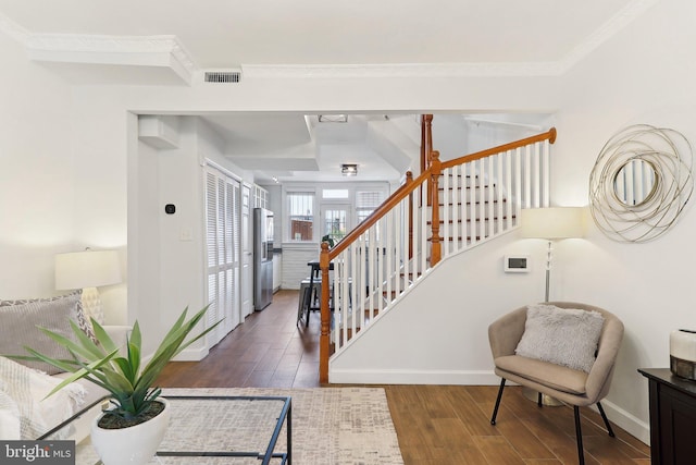 stairway featuring crown molding and hardwood / wood-style flooring