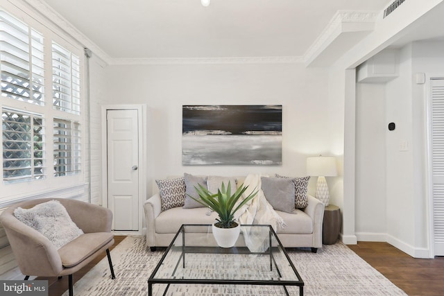 living room with hardwood / wood-style floors and crown molding