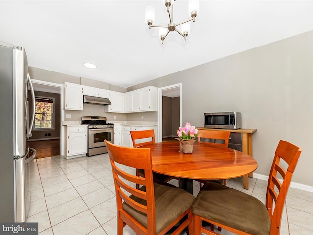 dining space with light tile patterned floors and a notable chandelier