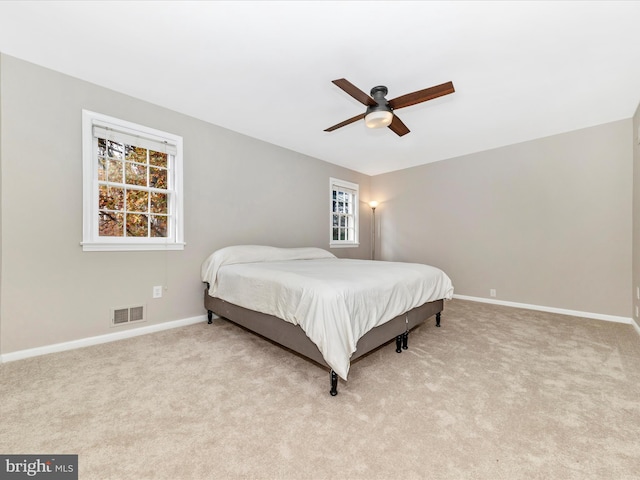 bedroom featuring ceiling fan and light carpet