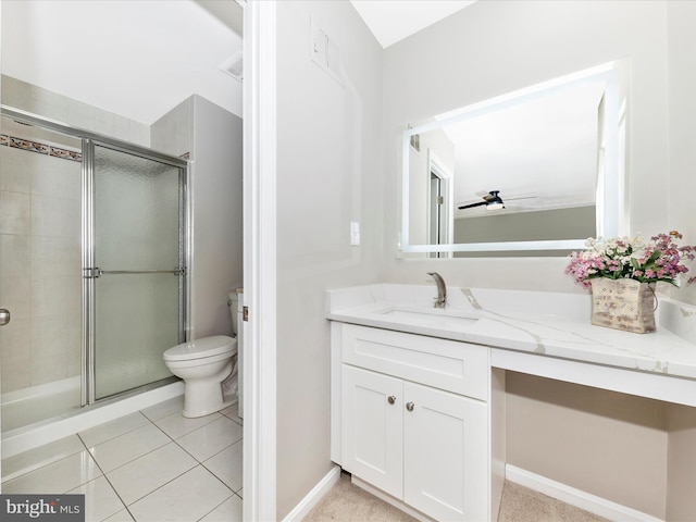 bathroom featuring vanity, toilet, an enclosed shower, and ceiling fan