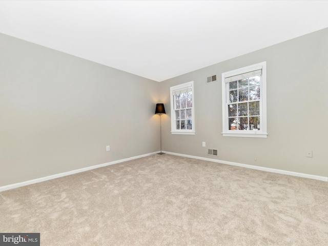 unfurnished room featuring light colored carpet