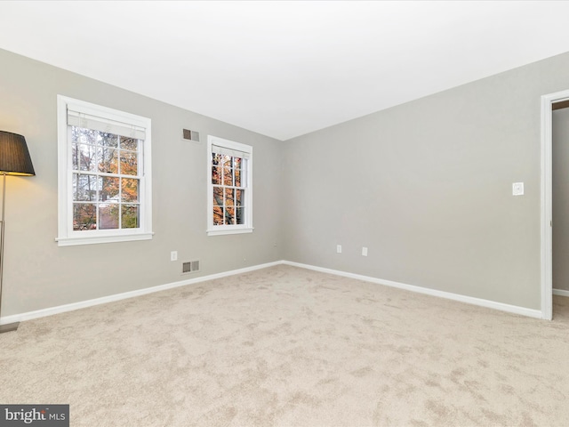 empty room featuring light colored carpet