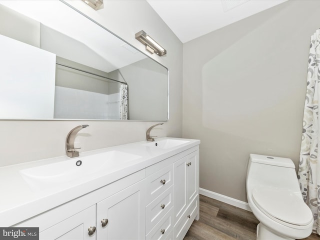 bathroom featuring walk in shower, hardwood / wood-style floors, vanity, and toilet