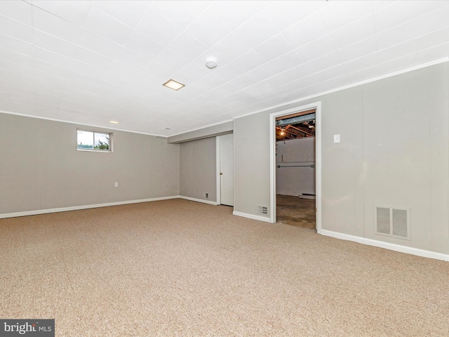 basement with carpet and crown molding