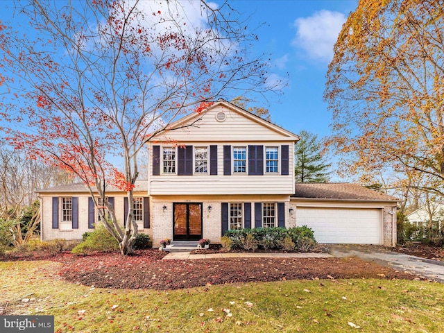 view of front of property featuring a garage and a front lawn