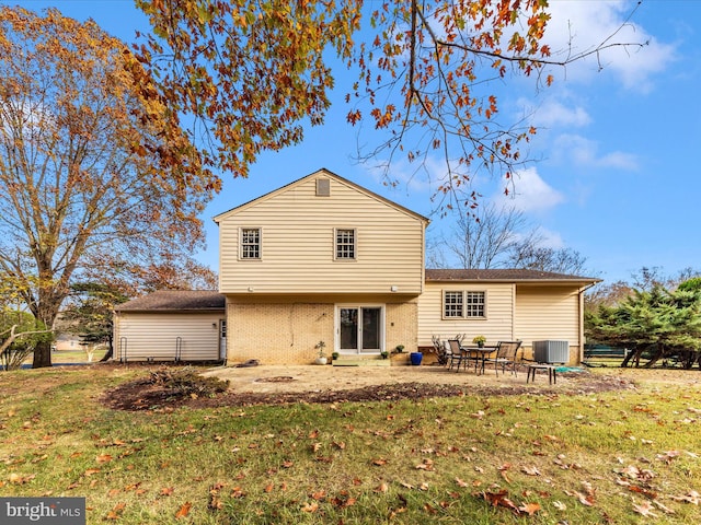 back of house with a patio area, a yard, and central AC