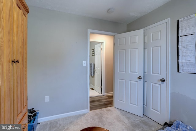 bedroom with a textured ceiling and light colored carpet