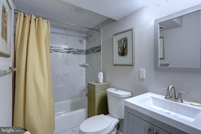 full bathroom featuring vanity, shower / bath combo with shower curtain, and toilet