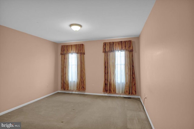 unfurnished room featuring light colored carpet