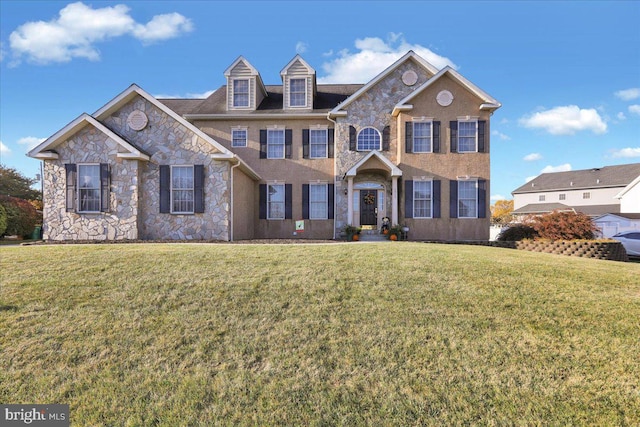 colonial inspired home featuring a front yard